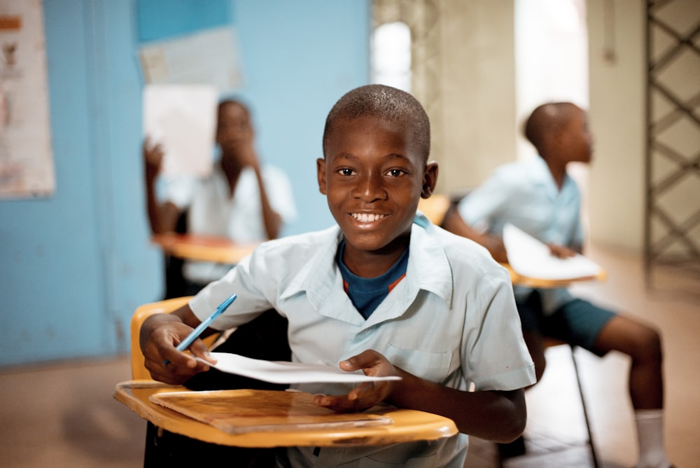 boy holding white paper