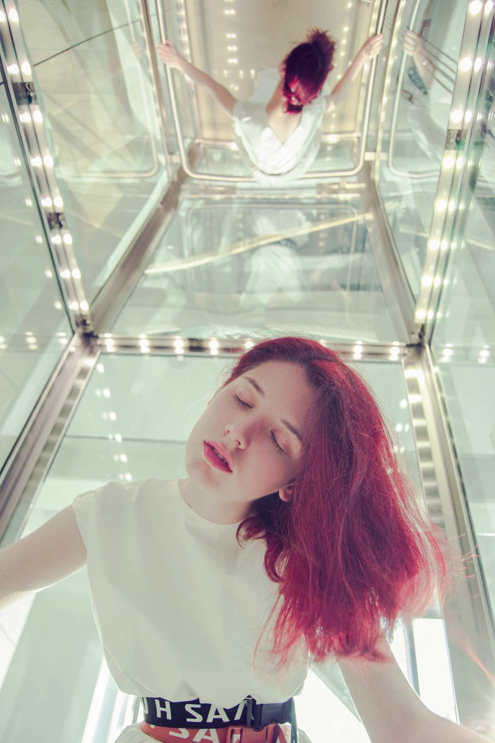 woman closing eyes inside elevator