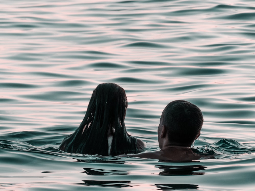 man and woman on body of water