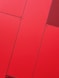 a close up of a red wall with metal rivets