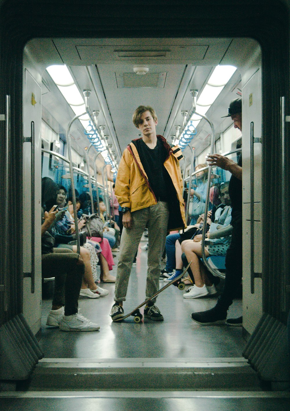 man wearing gray pants inside train