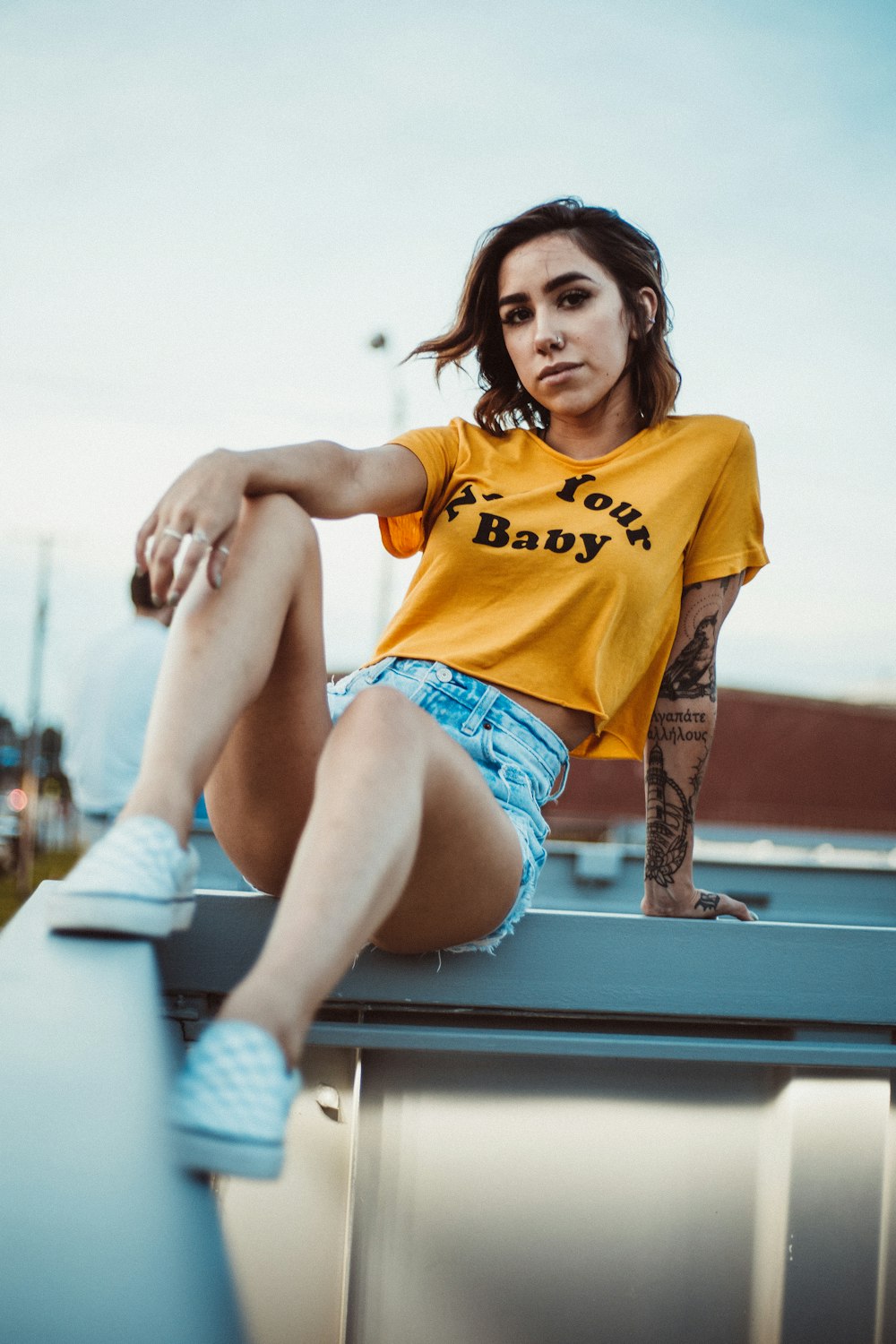 woman sitting on white wooden rail