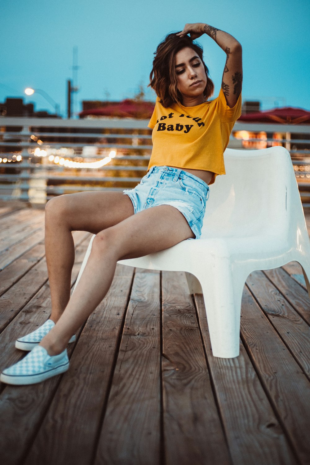 woman sitting on chair while hand on head