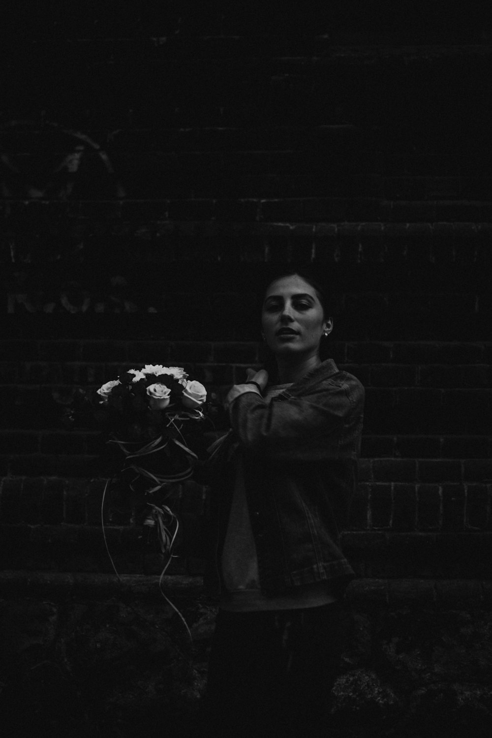 grayscale photography of woman holding flower bouquet