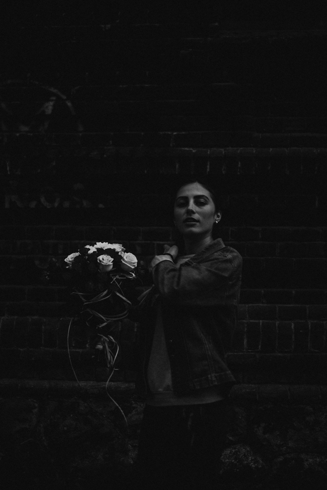 grayscale photography of woman holding flower bouquet