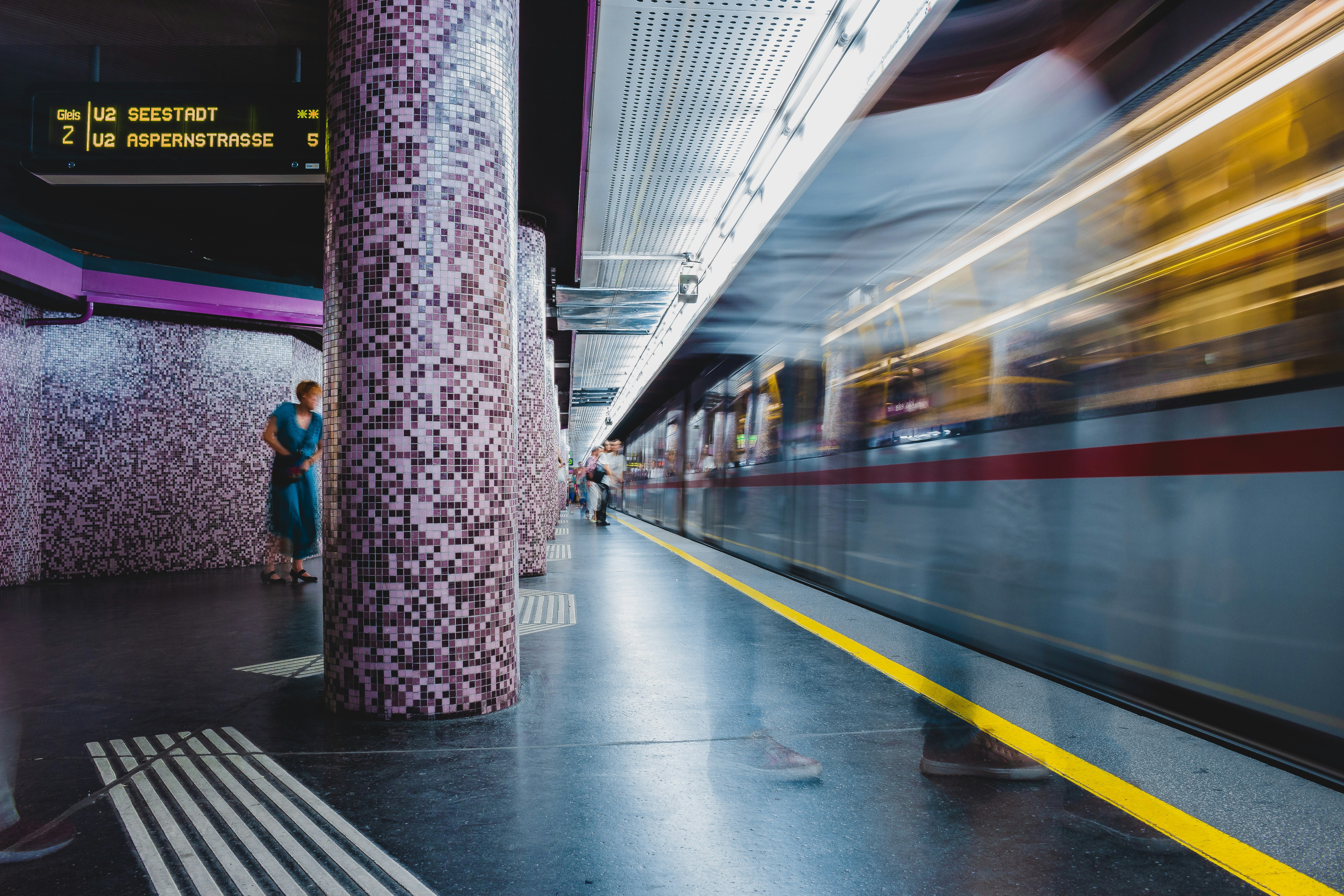 timelapse photo of train passing by station, Subway people