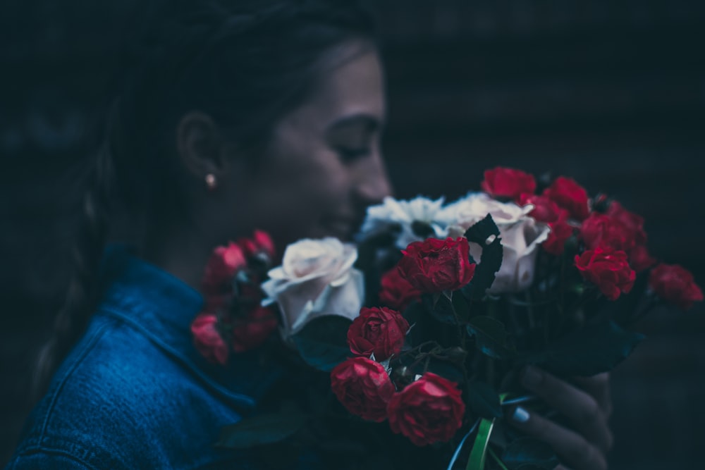 woman holding red and white rose flowers