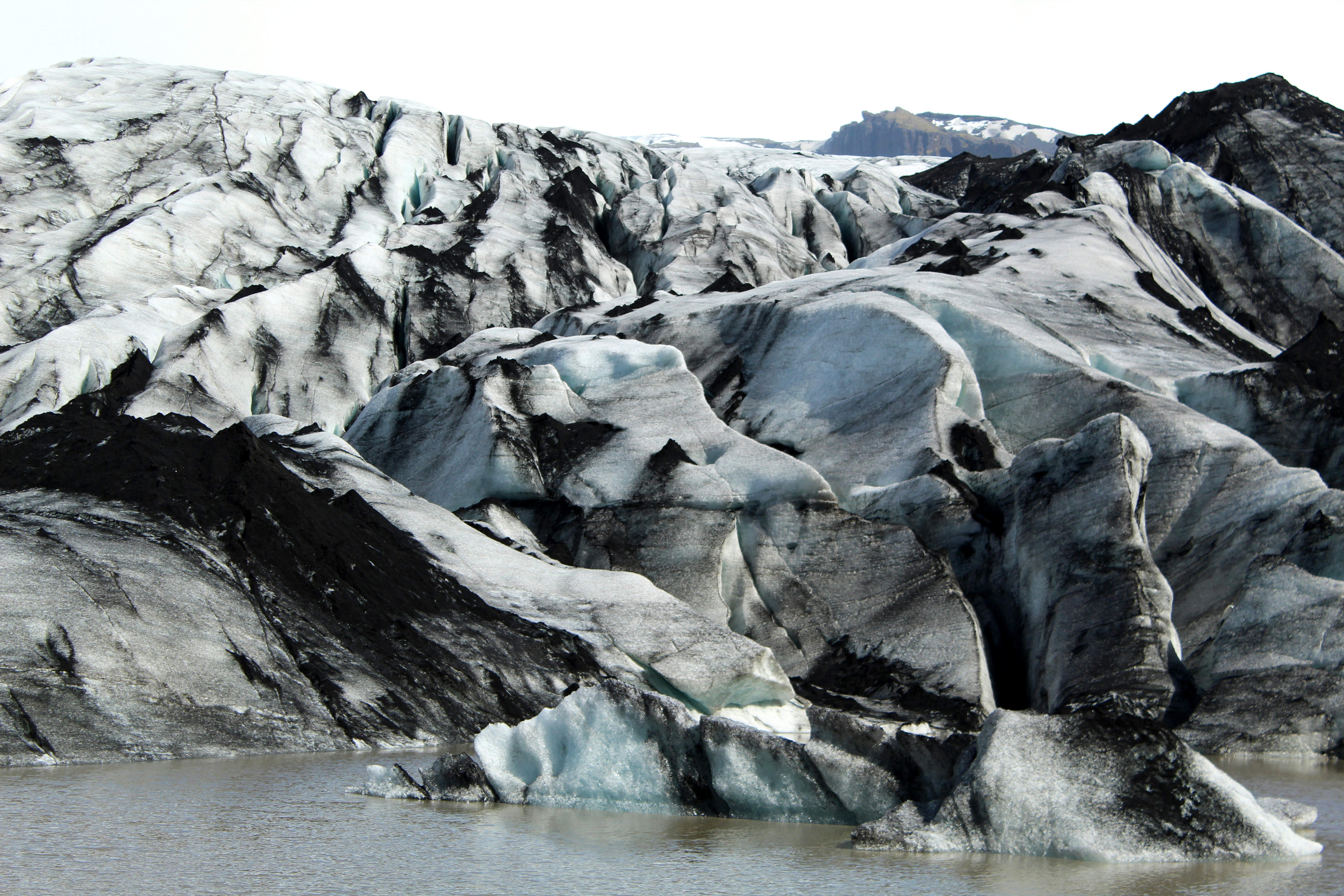 gray rock formation near body of water during dayrime
