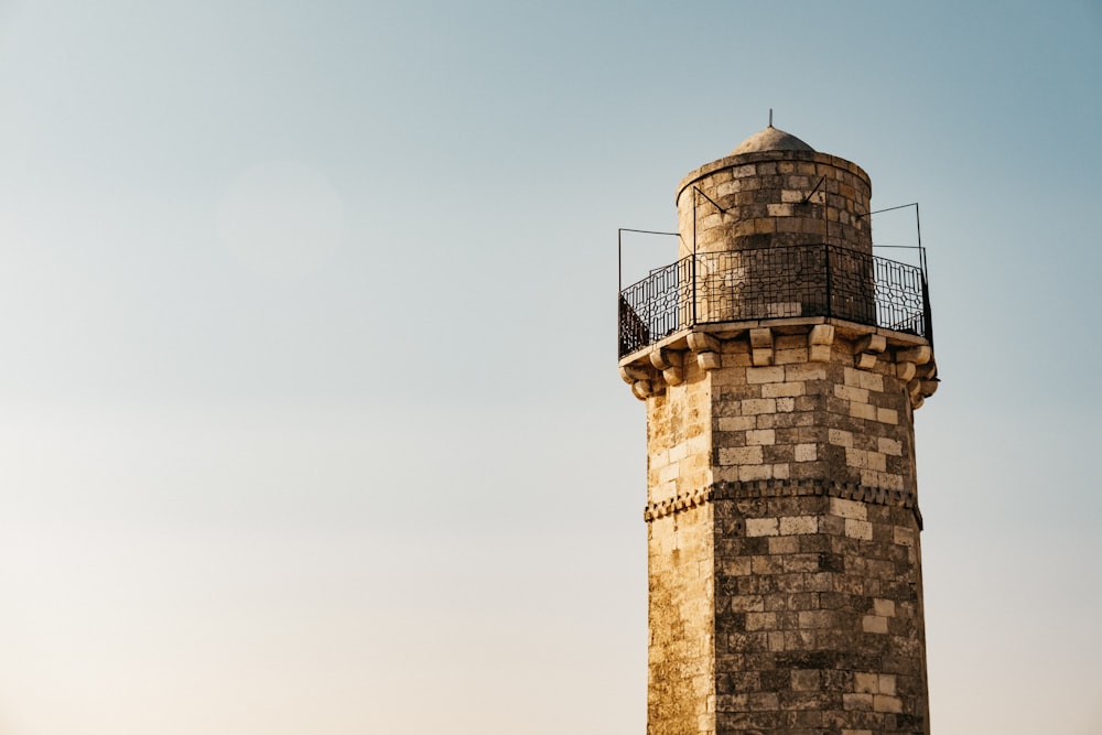 a tall brick tower with a clock on top