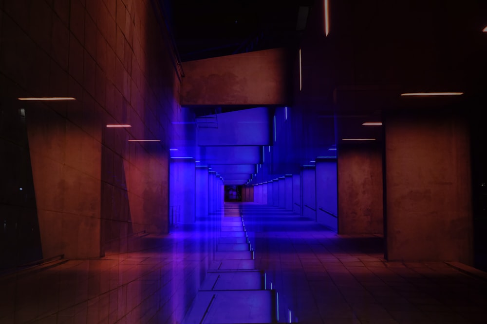 a long hallway with blue lights on the walls