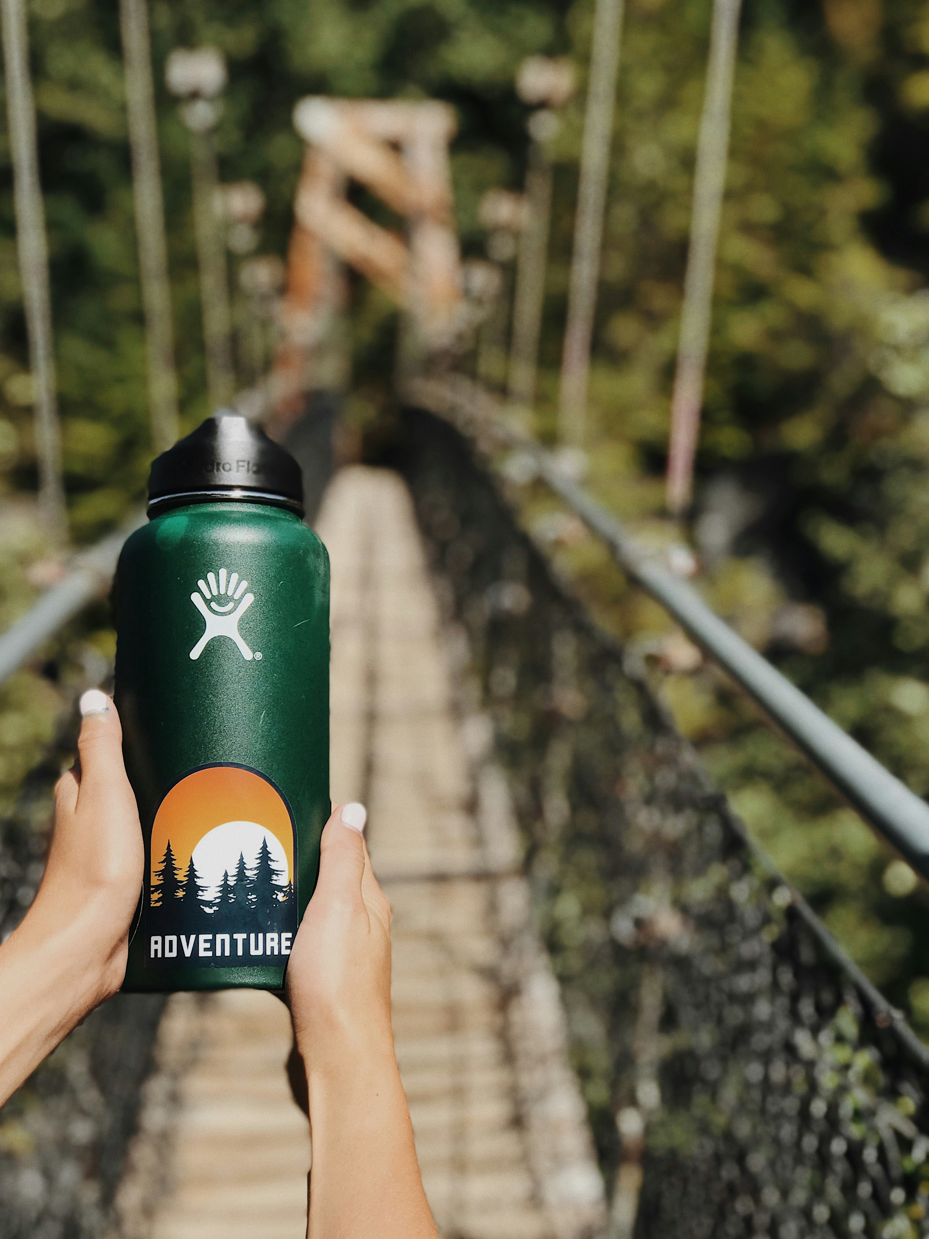 person holding green tumbler