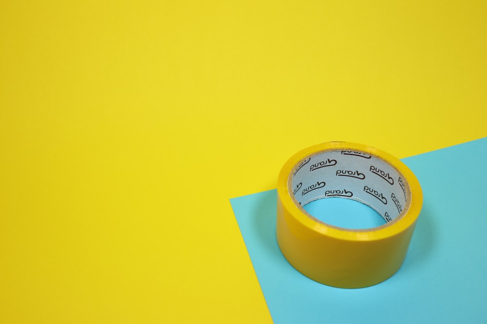 yellow duct tape on blue surface