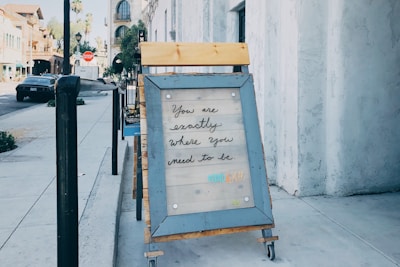 brown framed text beside street