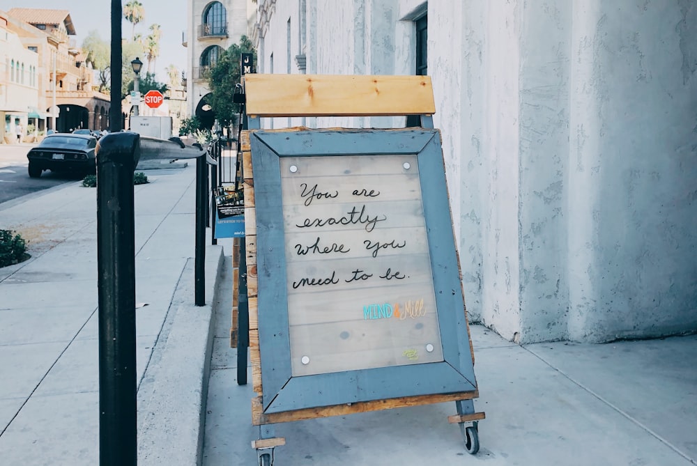 brown framed text beside street