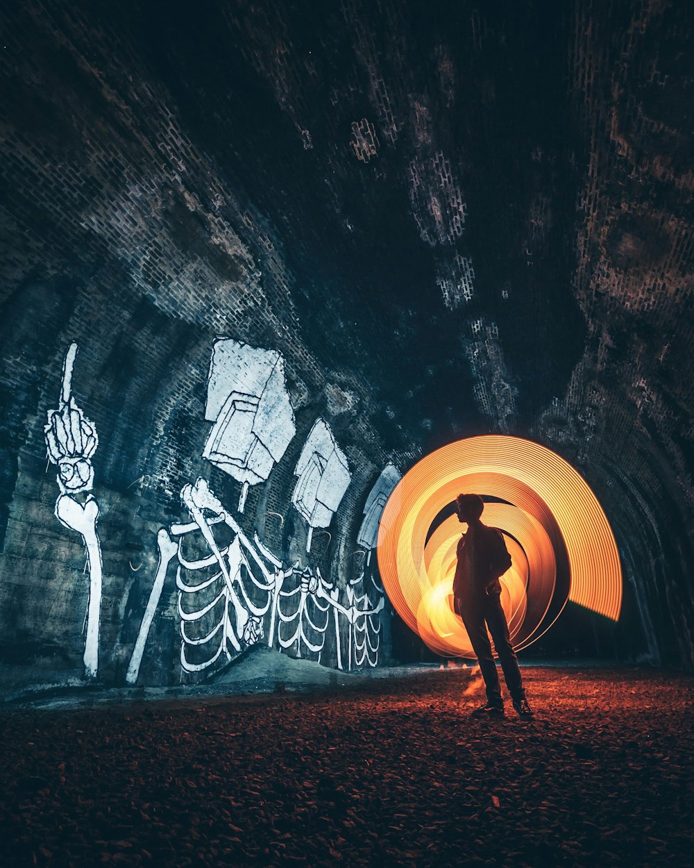 silhouette of person standing inside tunnel