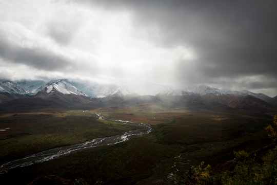 mountain range under white clouds during daytime in Denali National Park and Preserve United States