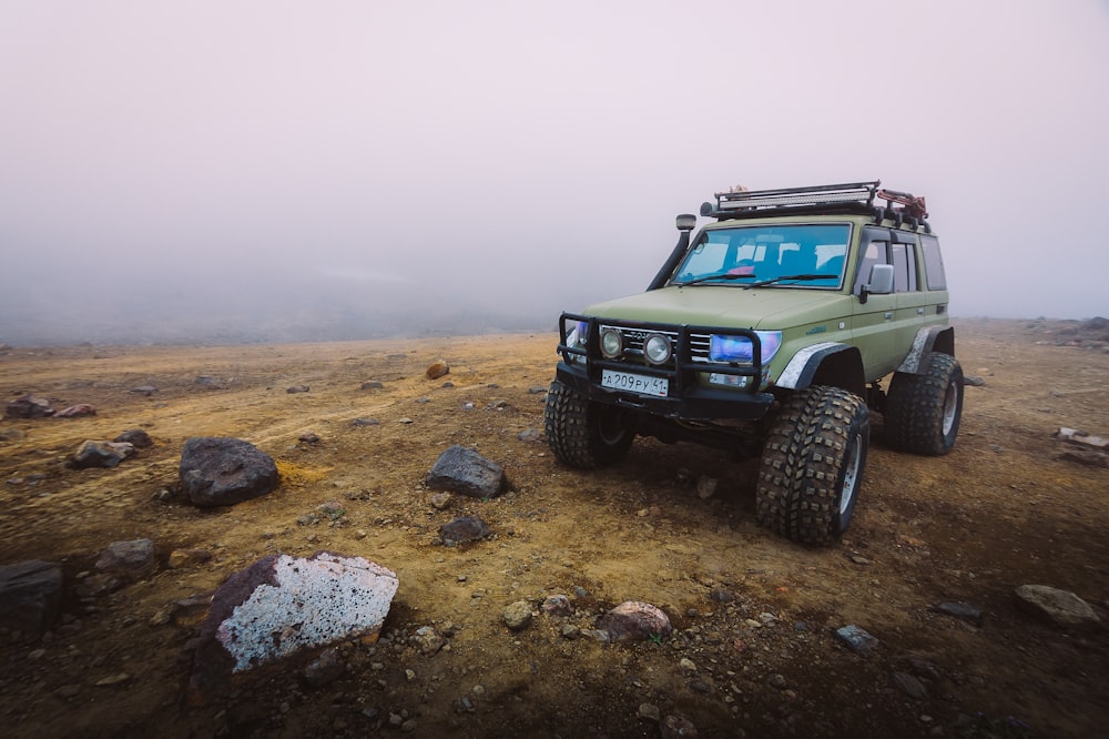 green utility vehicle on brown soil