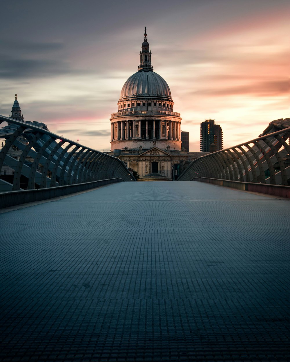 photo of foot bridge with background of temple