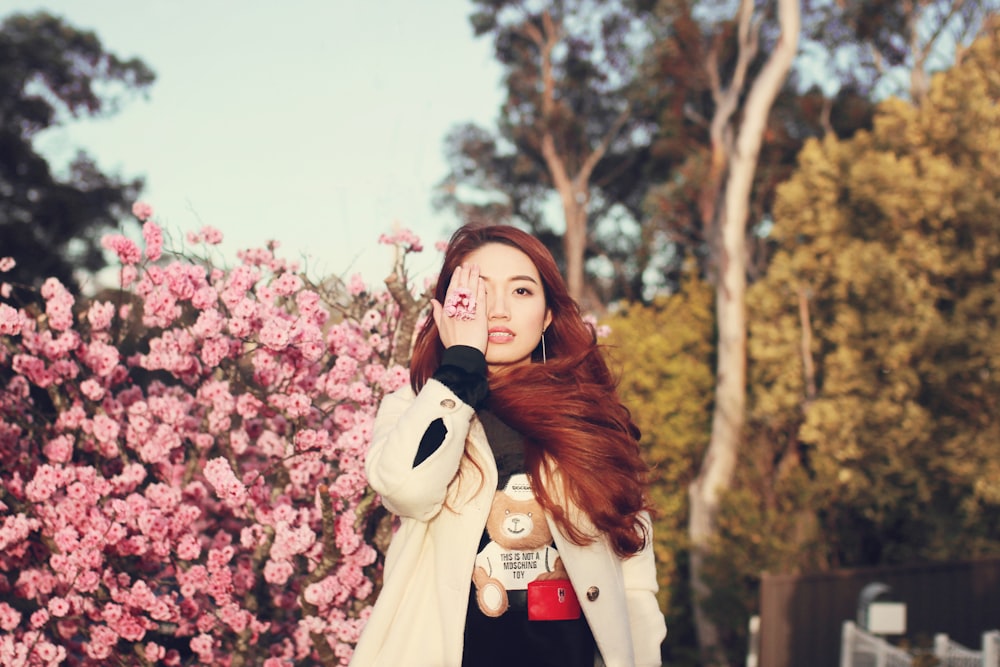 woman in front of pink flowering tree