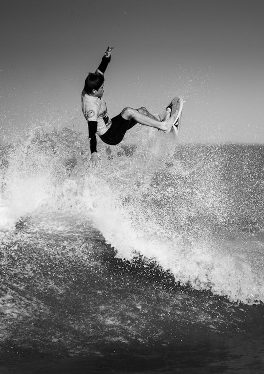 black and white photo of man surfing in Lacanau Océan France