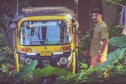 man standing beside of auto-rickshaw