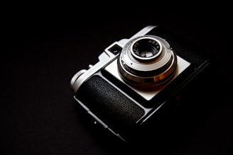 silver and black point-and-shoot camera