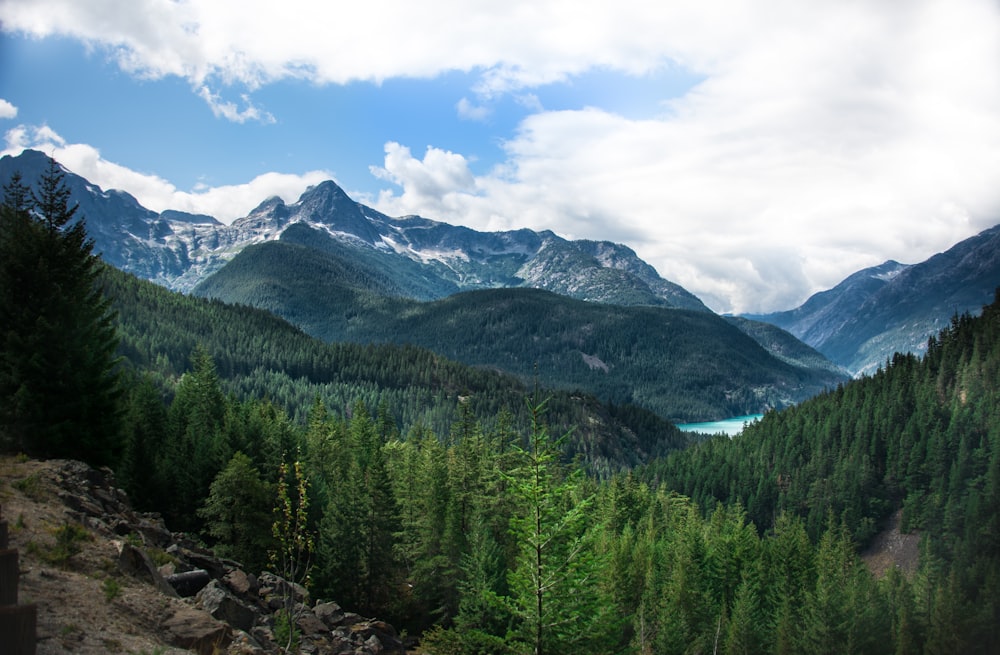 mountain covered with snow under blue and white skies