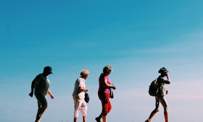 four people walking candid zoom background
