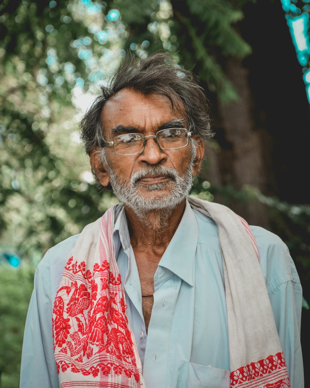 close-up photo of man in white and red floral scarf