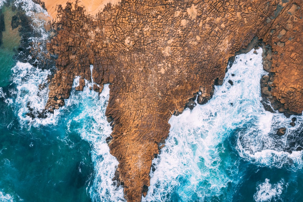 aerial photo of rock ledge and water