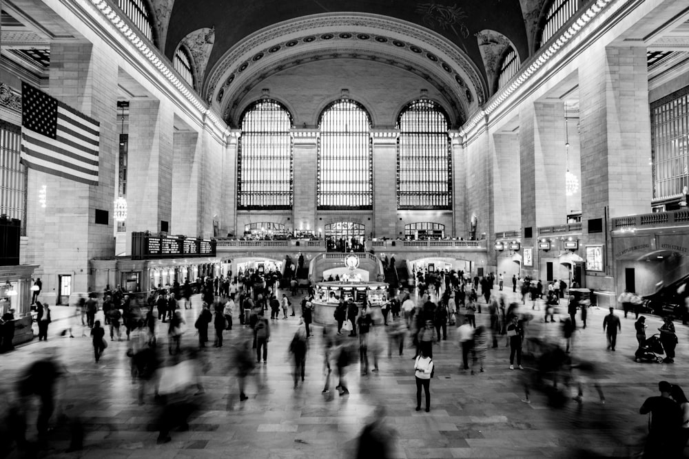 grayscale photography of people inside building