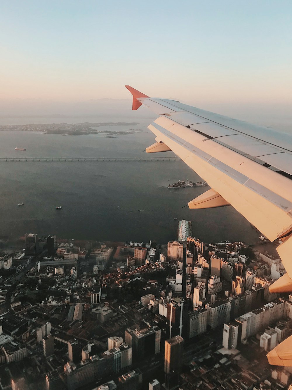 aerial view of plane wings and view of high-rise buildings