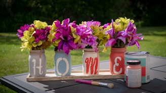 pink and yellow petaled flower lot on desk