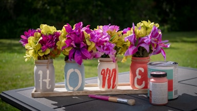 pink and yellow petaled flower lot on desk