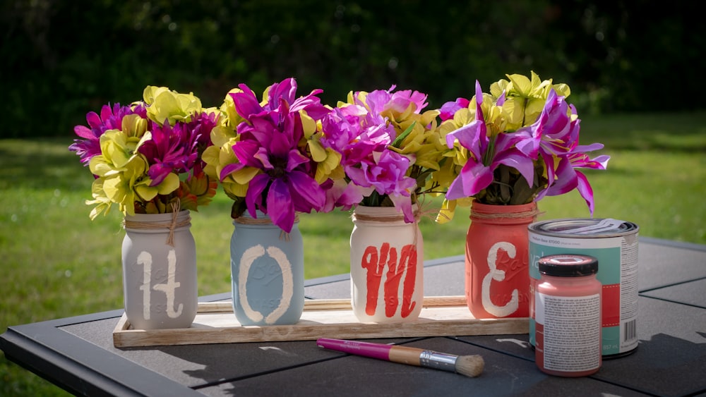 pink and yellow petaled flower lot on desk