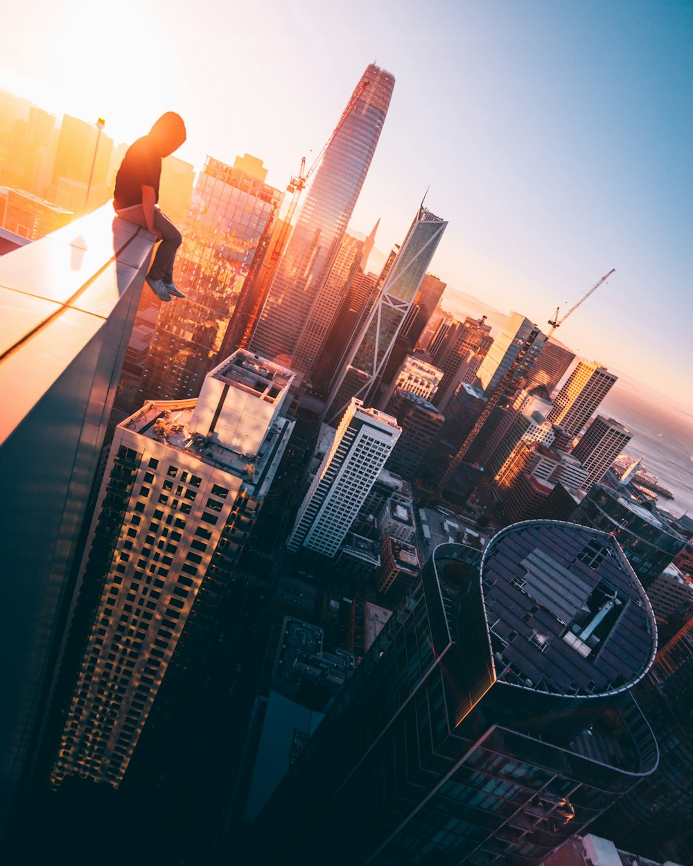 person sitting on top of building during daytime