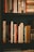 person taking photo of book lot