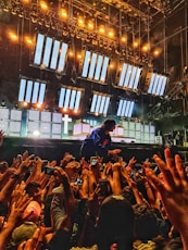 Energetic live concert scene with dynamic lighting and immersive video displays