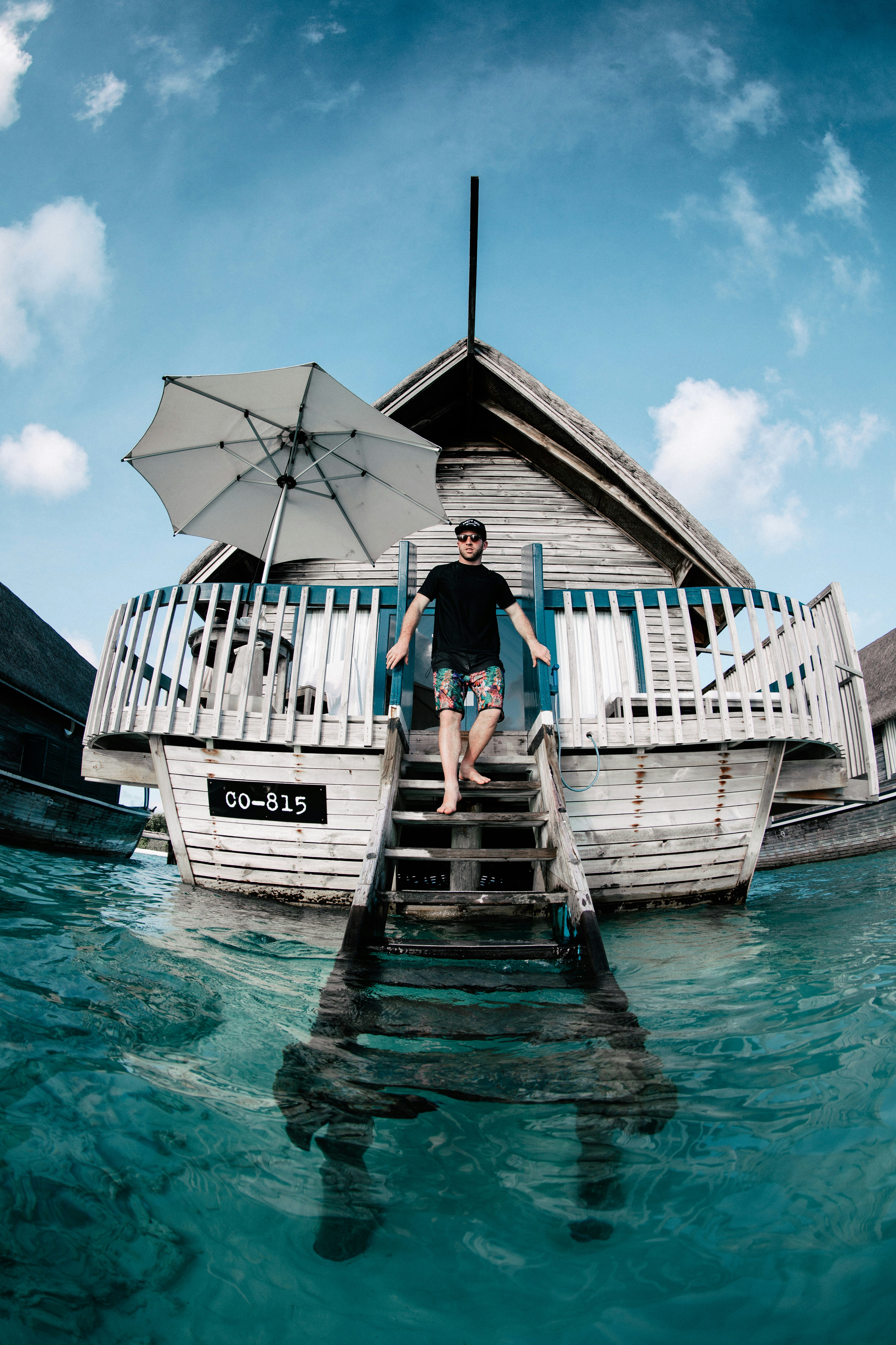 man in black T-shirt on gray wooden stairs