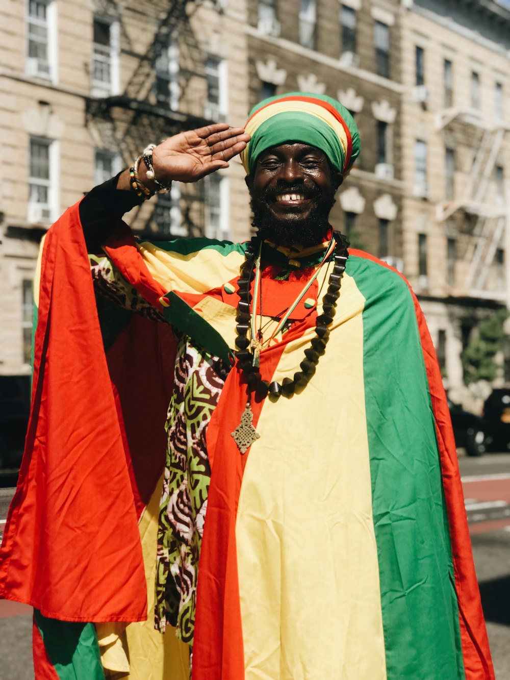 smiling man making hand salute