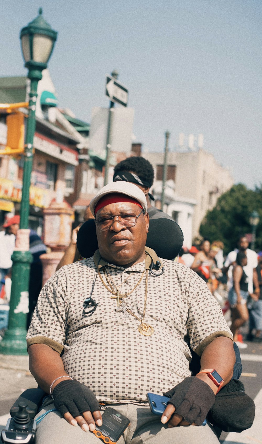 man sitting on motorized wheelchair on street at daytime