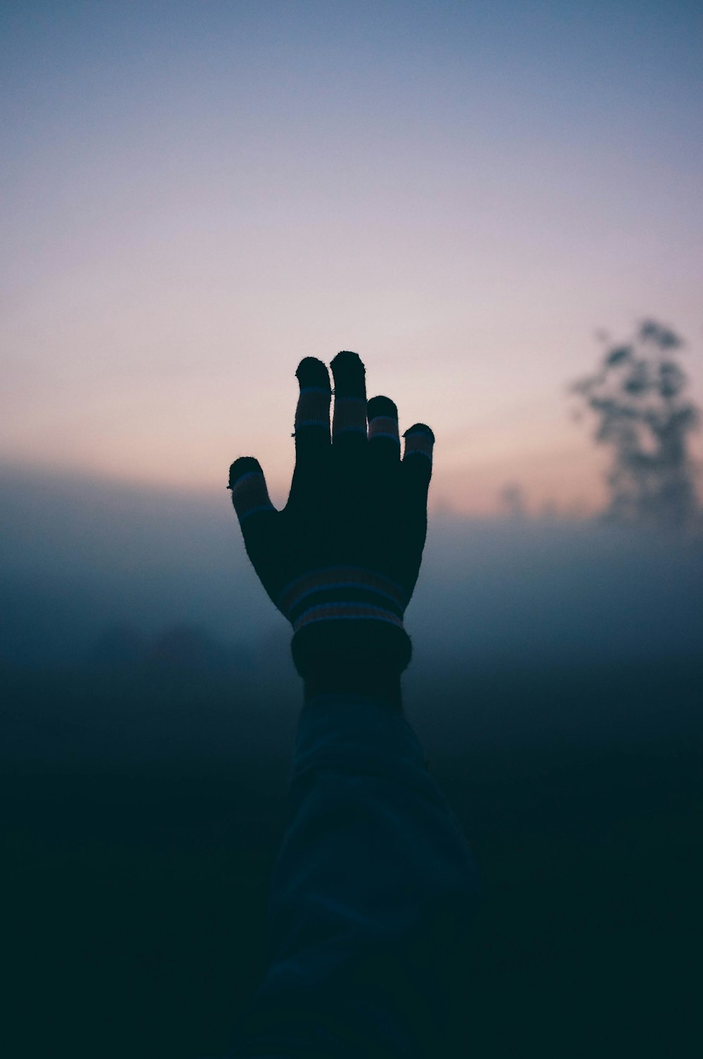 a person holding their hand up in the air