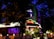 A building is illuminated at night, featuring a bright neon sign that reads 'China Valley'. The structure is surrounded by trees and foliage, with lamps enhancing the warm ambiance. Decorative red lanterns hang in front of the entrance, contributing to an inviting atmosphere.