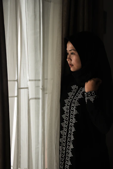 Portrait of a thoughtful Islamic instructor teaching a class with warm lighting.