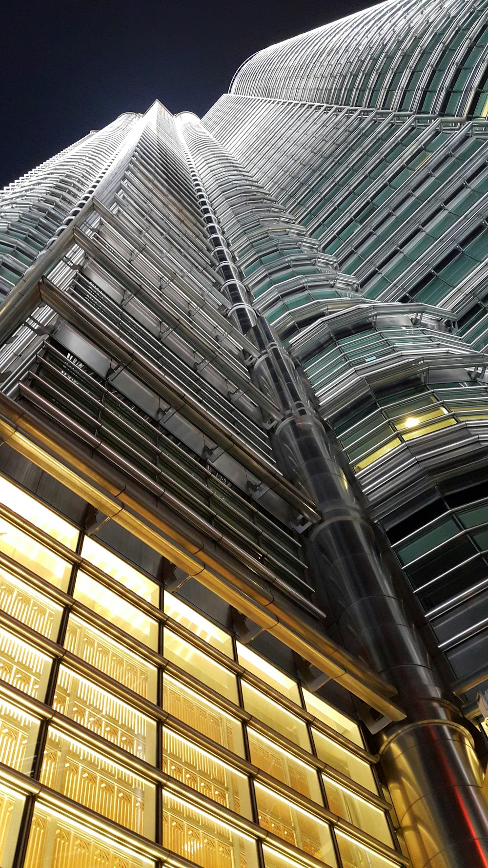 low-angle photography of high-rise building by night