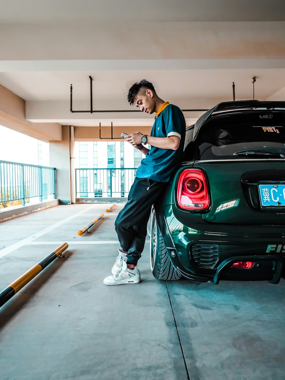 man leaning on green vehicle