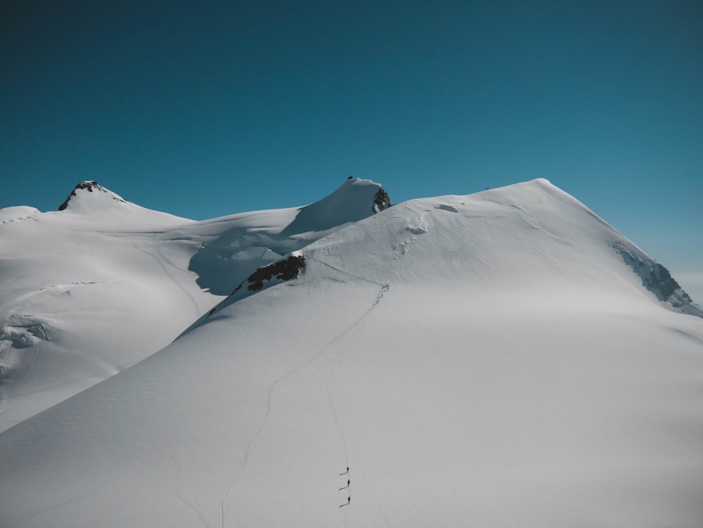 snow-covered mountain under blue clear sky during daytime