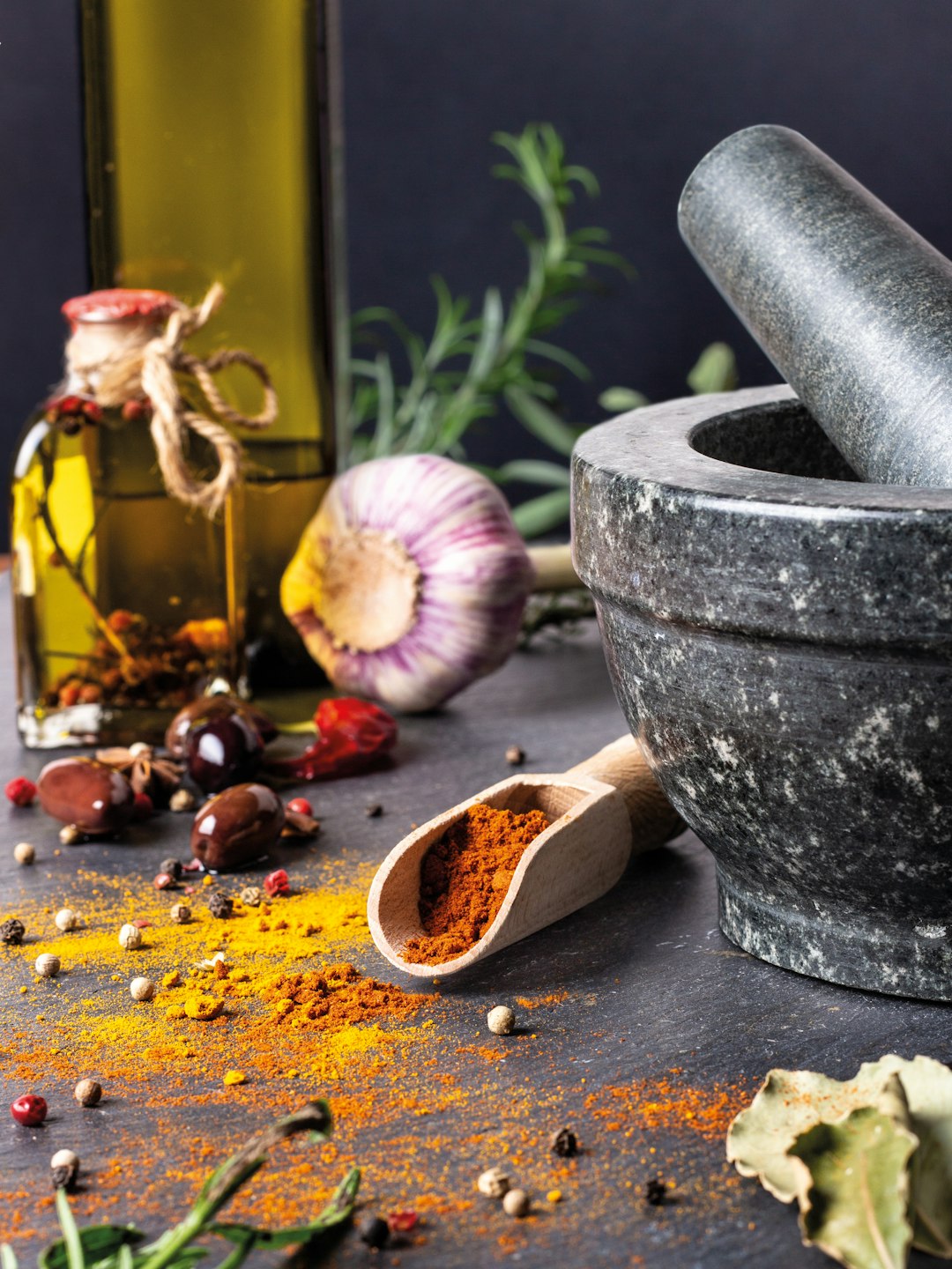 onion and black peppers beside black mortar and pestle