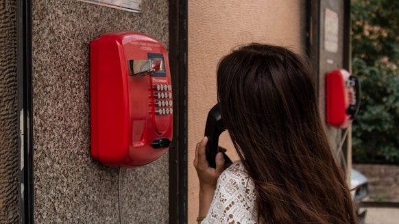 woman using payphone