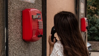 woman using payphone